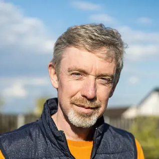 Middle aged man smiling after using a product that supports urinary comfort and daily routine